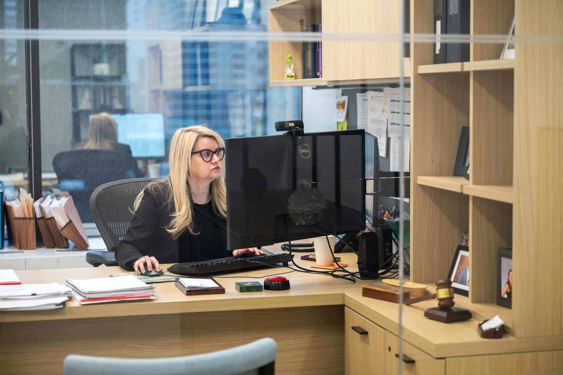 Image of Hillary A. Frommer working at her computer in her office.